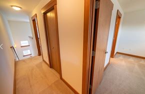 Seattle apartment for rent - a bedroom with a closet and a hallway with three doors