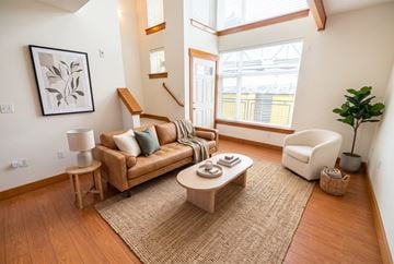Seattle apartment for rent - A living room with a brown sofa and a white chair.