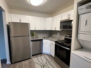 Baltimore apartment for rent - a kitchen with stainless steel appliances and white cabinets