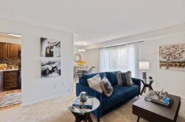 Baltimore apartment for rent - a living room with a blue couch and a table
