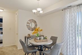 Baltimore apartment for rent - a dining room with a table and chairs and a window