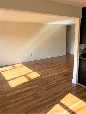 Garnerville apartment for rent - an empty living room with wooden floors and white walls