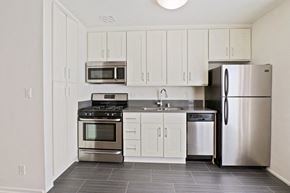 Brentwood apartment for rent - A kitchen with white cabinets and stainless steel appliances.