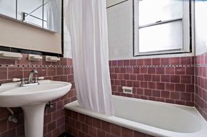Beverly Hills apartment for rent - A white sink is on the left of a white bathtub in a bathroom.