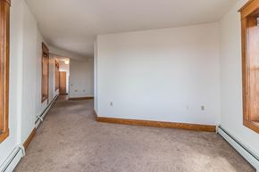 Devils Lake apartment for rent - a living room with a white wall and a carpeted floor
