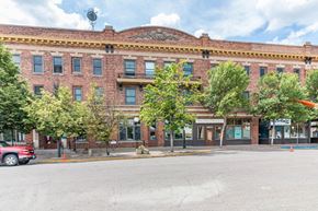 Devils Lake apartment for rent - a brick building with trees in front of it on a street