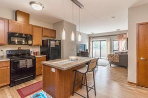 Minneapolis apartment for rent - a kitchen with a center island with two stools