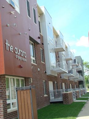 Grand Forks apartment for rent - a brick apartment building with balconies and a sidewalk