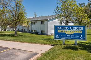 Whitewood apartment for rent - a building with a sign in front of it