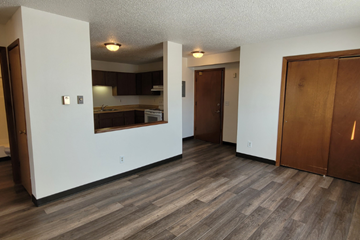 Whitewood apartment for rent - the living room and kitchen of an empty apartment