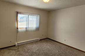 Whitewood apartment for rent - the living room of an empty house with a window