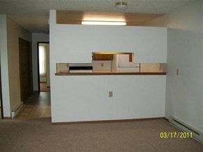 Sturgis apartment for rent - an empty living room with a white wall and a kitchen