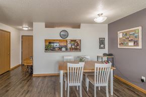 Bismarck apartment for rent - a dining room with a wooden table and chairs