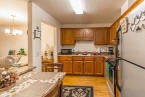 Monticello apartment for rent - a kitchen with wooden cabinets and stainless steel appliances