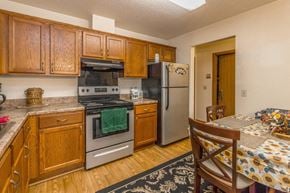 Monticello apartment for rent - a kitchen with stainless steel appliances and wooden cabinets