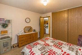 Monticello apartment for rent - a bedroom with a bed and a dresser and a clock on the wall