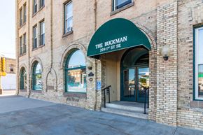 Little Falls apartment for rent - a brick building with a green awning on the front of it