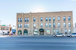 Little Falls apartment for rent - a large brick building on the corner of a city street