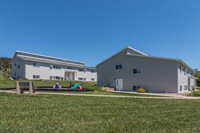 Sturgis apartment for rent - two houses with people sitting on a hammock in the grass