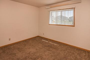 Sturgis apartment for rent - the living room of a home with a window and carpet