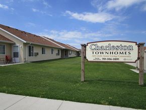West Fargo townhouse for rent - a sign sits in front of a green lawn