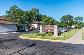 Little Falls apartment for rent - A sign for "Pillsbury Manor" stands in front of a parking lot.