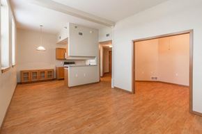 Grafton apartment for rent - an empty living room and kitchen with a wood floor
