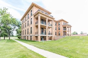 Grafton apartment for rent - a building on the side of a green lawn and a sidewalk
