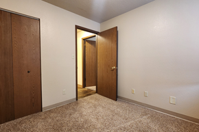 Jamestown apartment for rent - a bedroom with two doors and a carpeted floor