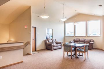 Bismarck apartment for rent - a living room with couches and a table and chairs
