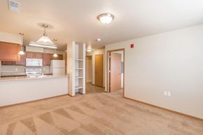 Bismarck apartment for rent - the living room and kitchen of an apartment with a door to the kitchen and a
