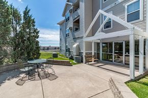 Bismarck apartment for rent - a patio with a table and chairs in front of a house