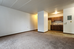 Jamestown apartment for rent - an empty living room with a kitchen in the corner