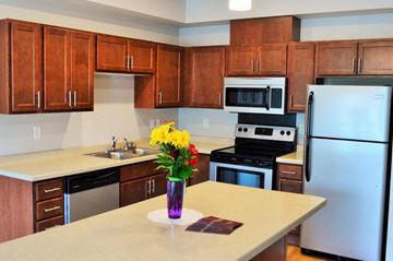 Jamestown apartment for rent - a kitchen with stainless steel appliances and wooden cabinets