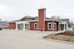Jamestown apartment for rent - the front of a red building with a parking lot