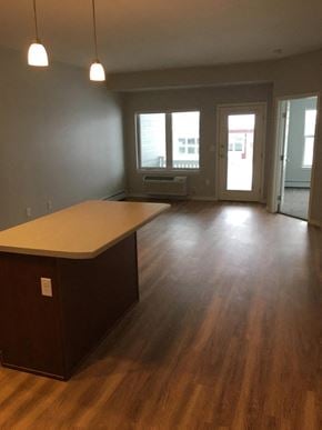 Jamestown apartment for rent - an empty living room with a kitchen and wood floors