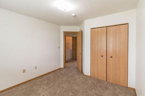 Buffalo townhouse for rent - a bedroom with a closet and a door to a bathroom