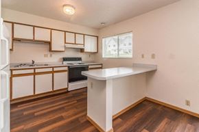 Buffalo townhouse for rent - an empty kitchen with white cabinets and a counter top