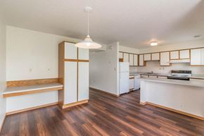 Buffalo townhouse for rent - an empty kitchen with white appliances and wood floors