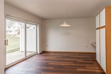 Buffalo townhouse for rent - a living room with a sliding glass door and wood floors
