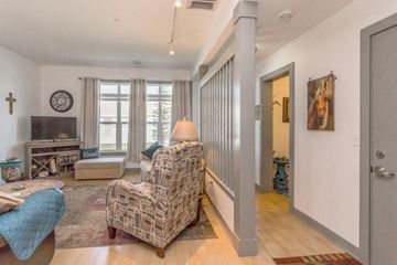 Mandan apartment for rent - a living room with a couch and a chair and a door to a hallway
