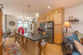 Mandan apartment for rent - a kitchen with a center island and a stainless steel refrigerator