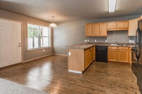 Cambridge apartment for rent - an empty kitchen with wooden floors and wood cabinets