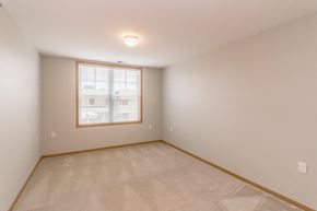 Mandan apartment for rent - the living room of a home with a large window and a tiled floor