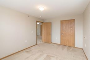Mandan apartment for rent - a bedroom with a door to a hallway and a closet