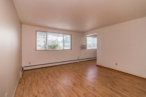 St Louis Park apartment for rent - the living room of an empty house with wood floors and a window