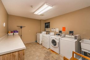 Waconia apartment for rent - a laundry room filled with washes and dryers