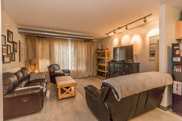 Minot apartment for rent - a living room with leather furniture and a tv