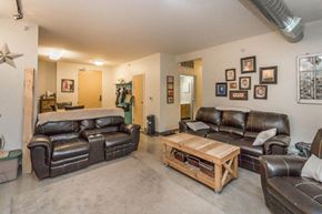 Minot apartment for rent - a living room with leather couches and a coffee table