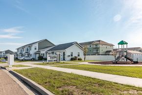 Minot apartment for rent - a group of houses with a playground in front of them